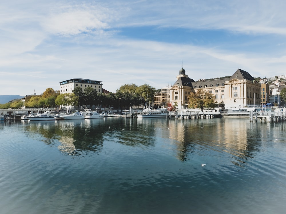 a body of water with boats in it and buildings in the back