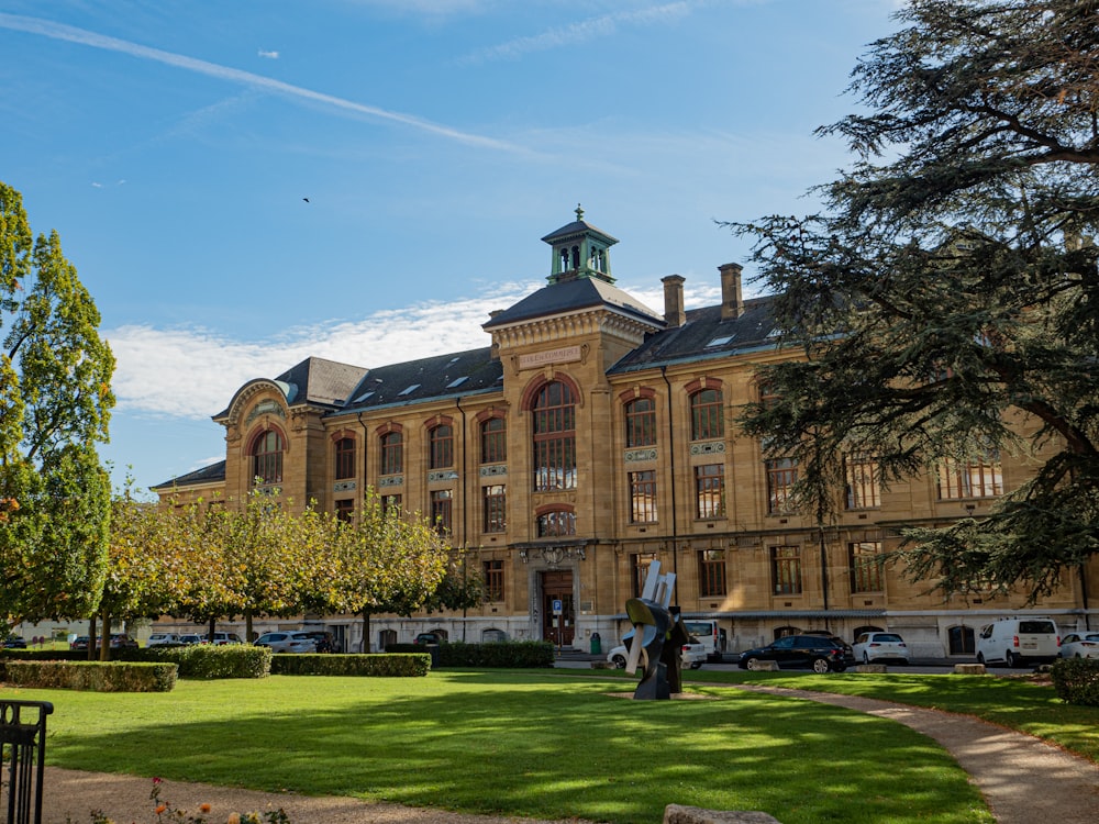 a large building with a lawn in front of it