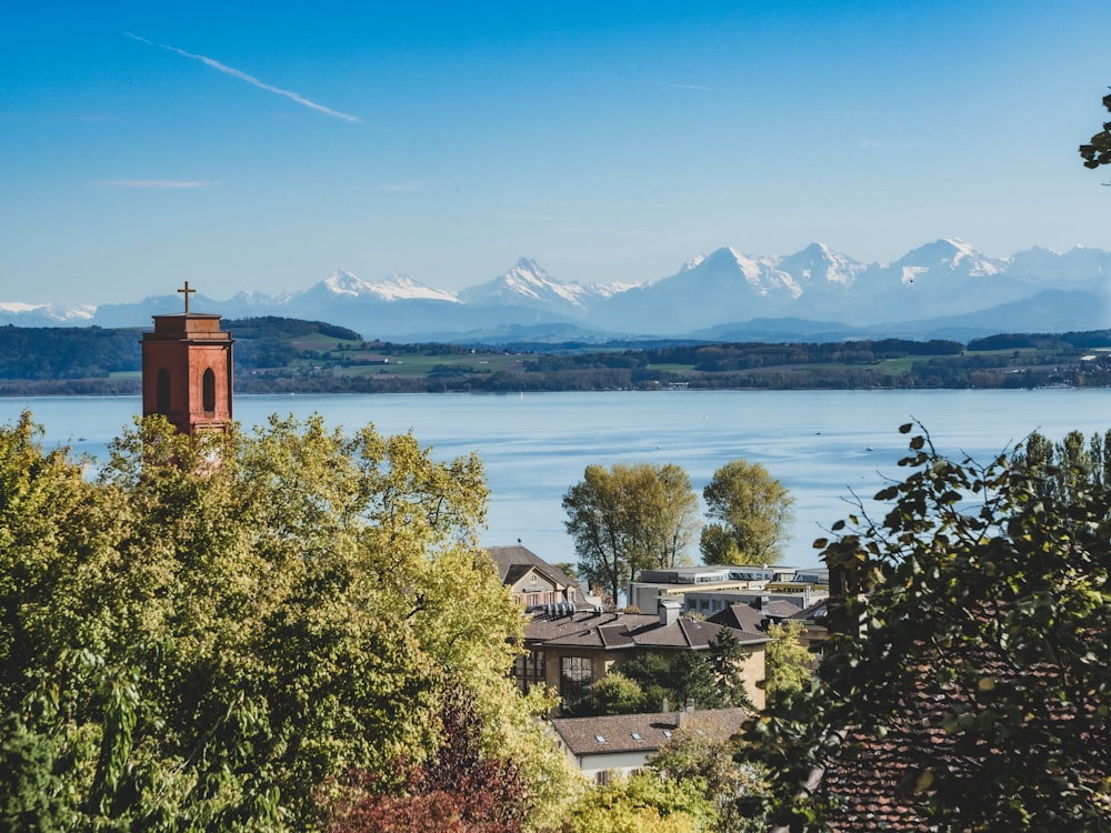 a town by the water with mountains in the background