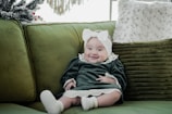 a baby sitting on a couch