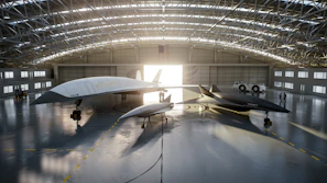 A panoramic view of a jet hangar with multiple aircraft gleaming under bright lights.