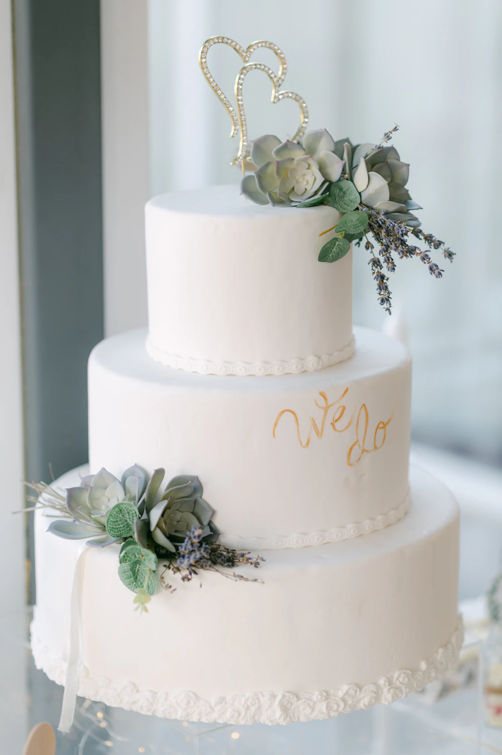 A white cake with a gold ribbon