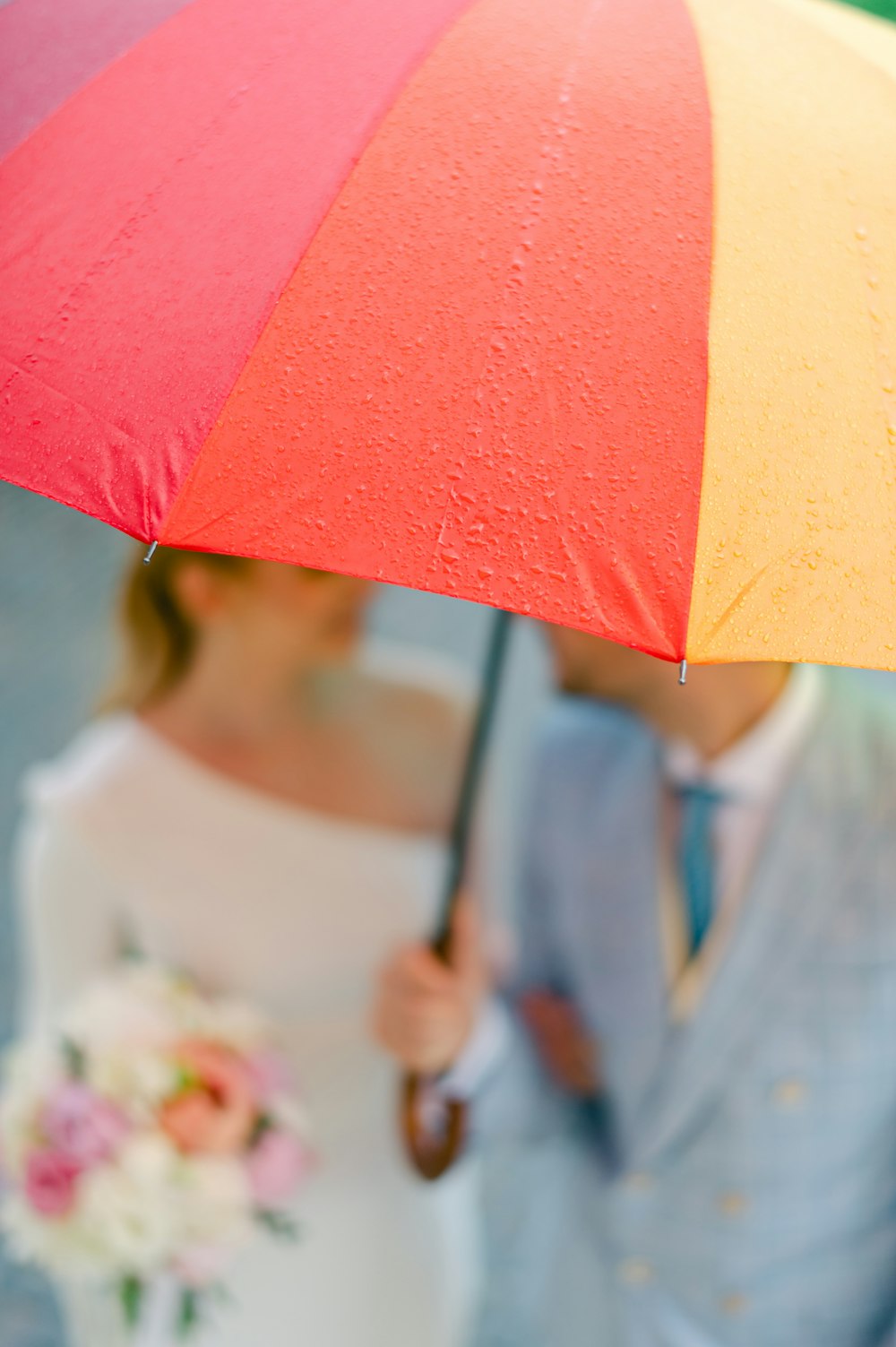 un paio di persone camminano sotto un ombrello