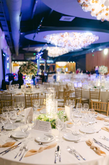 A beautifully decorated banquet hall with golden accents and ambient lighting, ready for a grand wedding celebration.