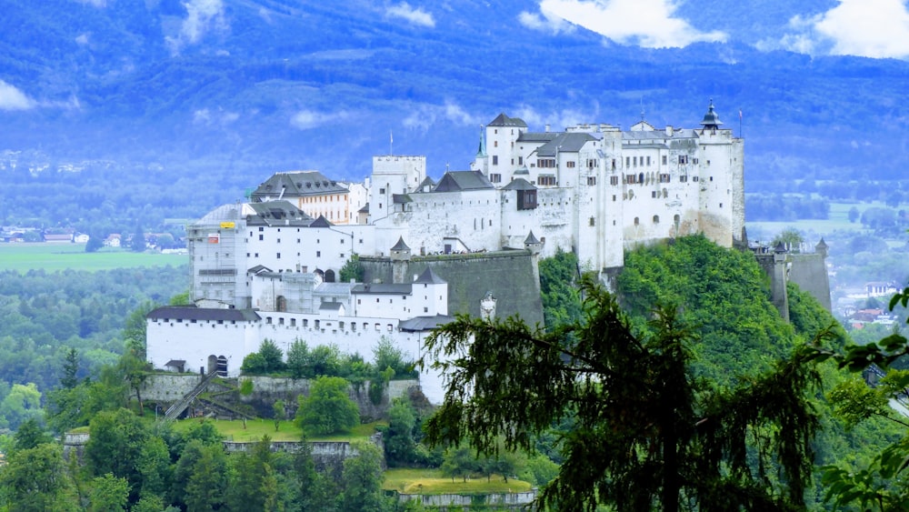 a large white building on a hill