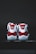 A pair of red and white athletic shoes with a glossy finish, placed on a dark surface. The shoes have white laces and a distinct logo on the heel.