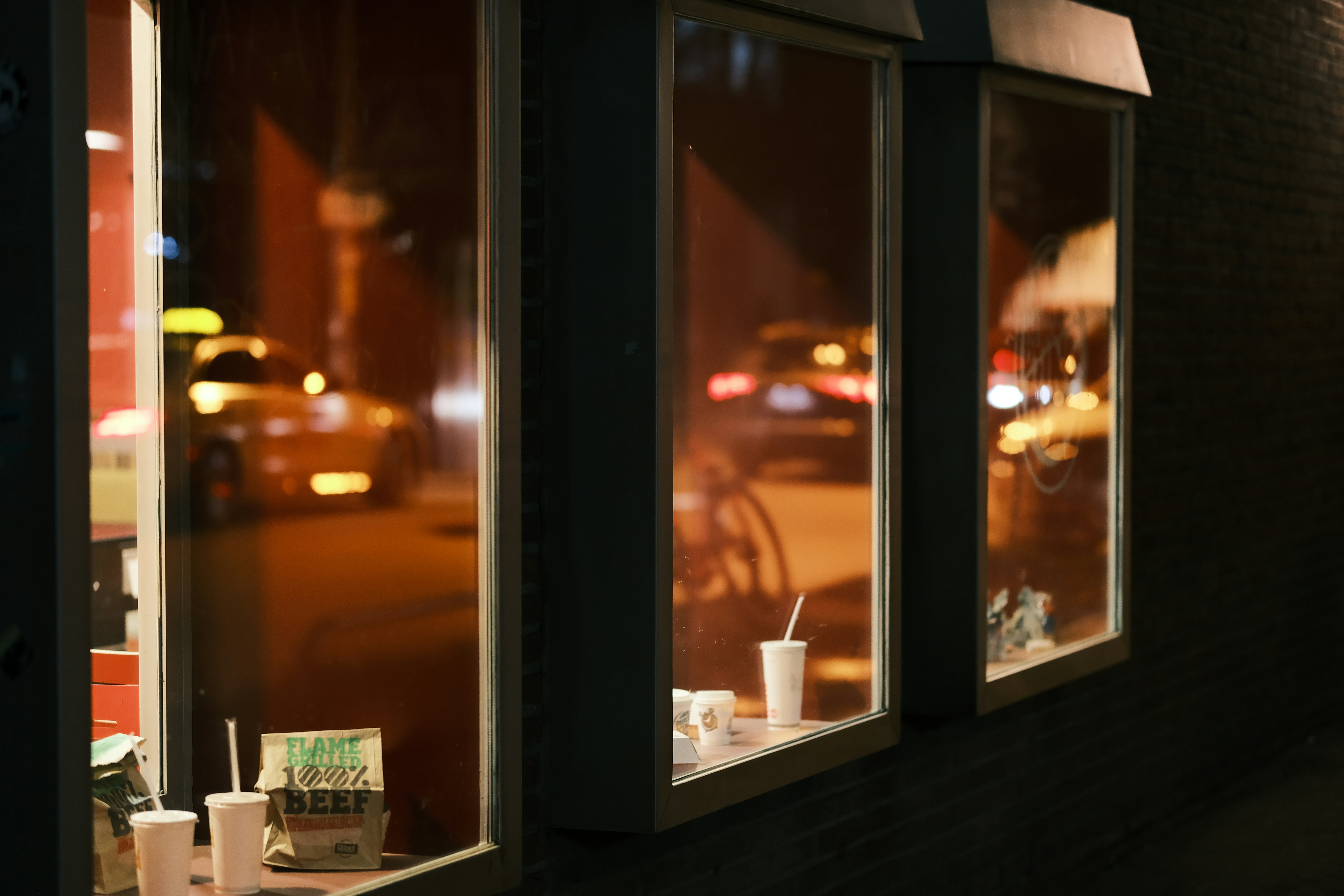 a window with a drink and food on it