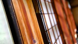 Close-up of handcrafted wooden shoji panels softly illuminated by natural light.