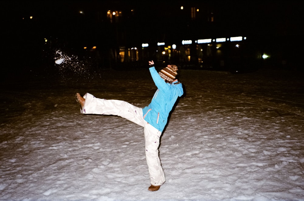 a person holding a dog on a snowy ground