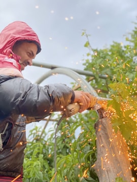 An influencer demonstrating eco-friendly tools on a wooden project outdoors