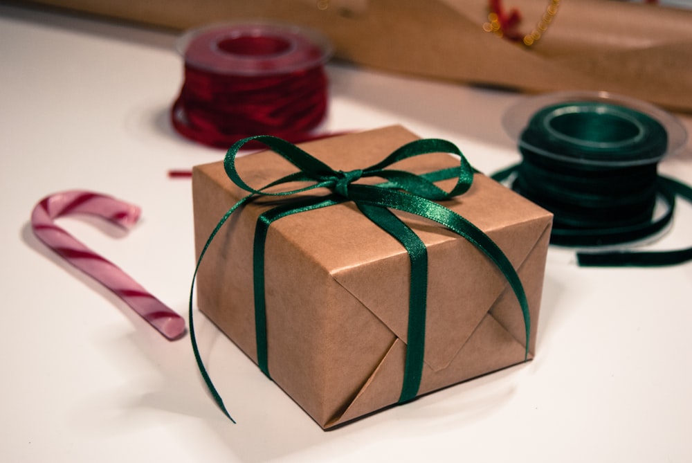 a green and white wrapped gift wrapped gift wrapped in green ribbon