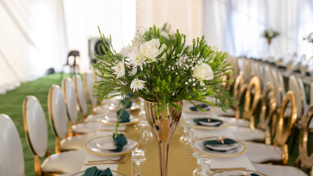 a vase with white flowers on a table