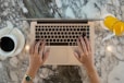 hands holding a laptop