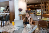 a person sitting at a table with a laptop