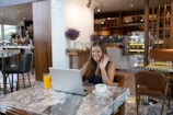 a person sitting at a table with a laptop