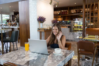 a person sitting at a table with a laptop