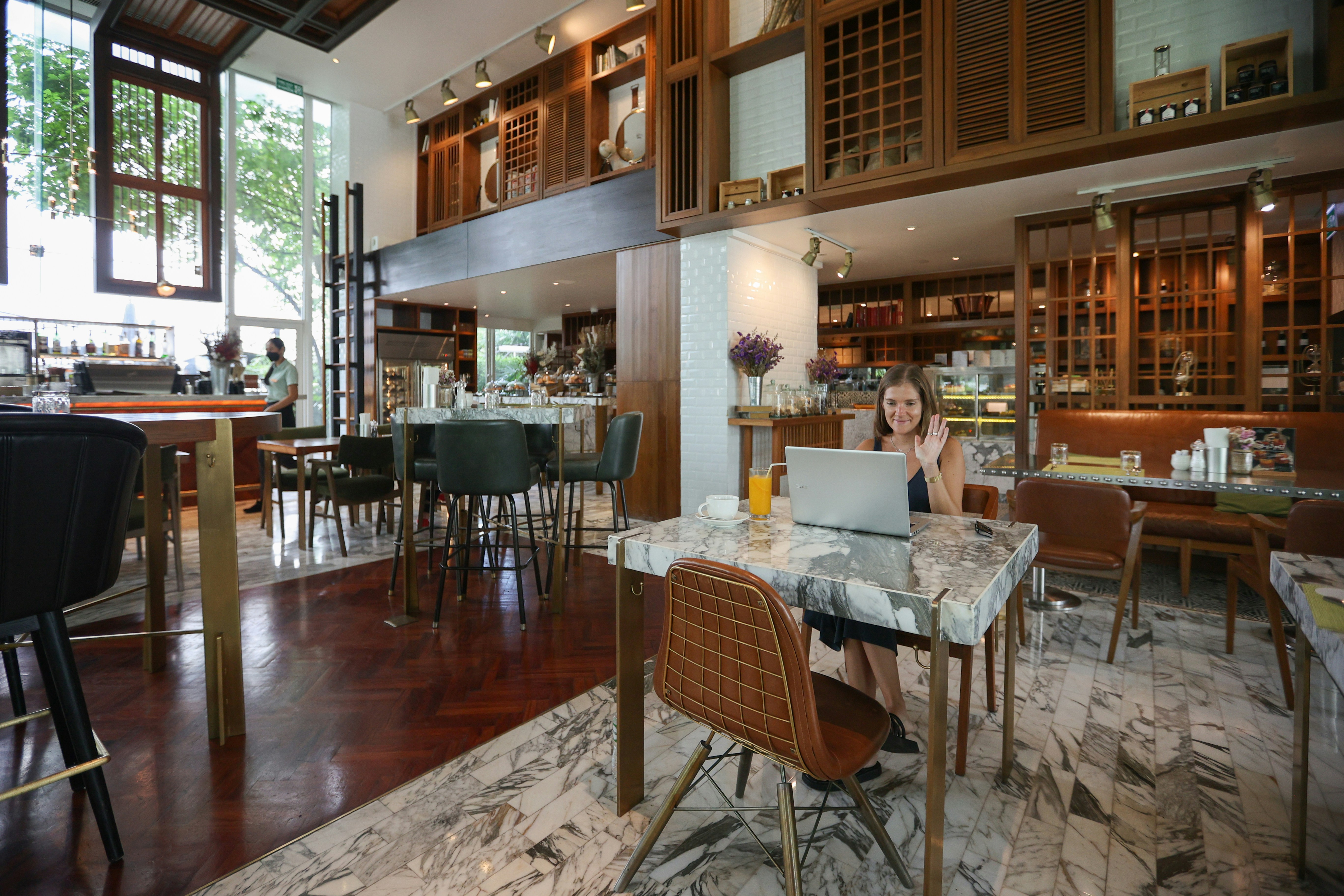 a person sitting at a table with a laptop