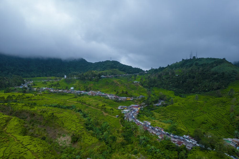 a landscape with a river running through it and a town in the distance