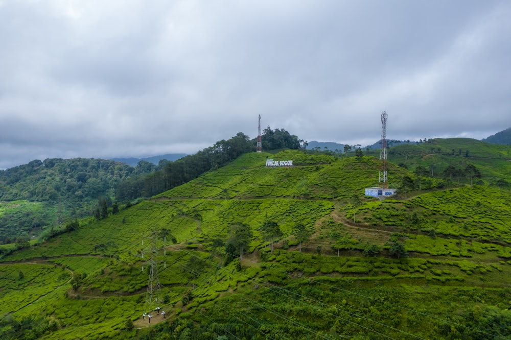 a grassy hill with a tower in the distance