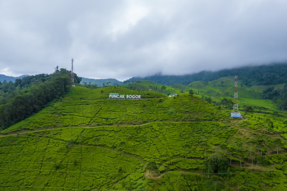 a green valley with a sign