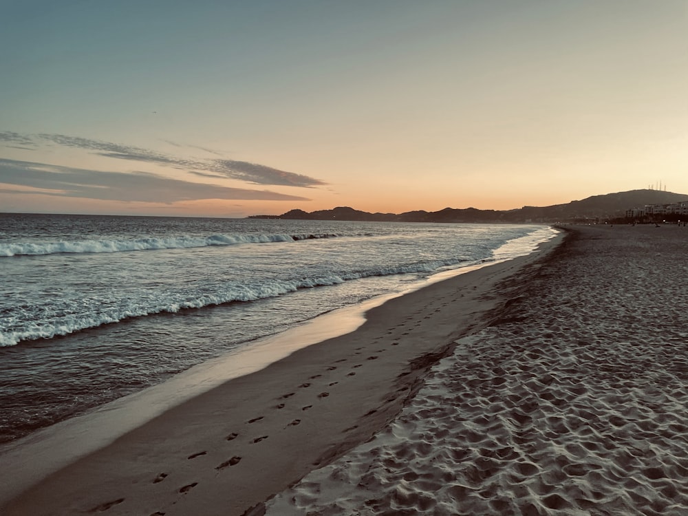 a beach with waves crashing on it