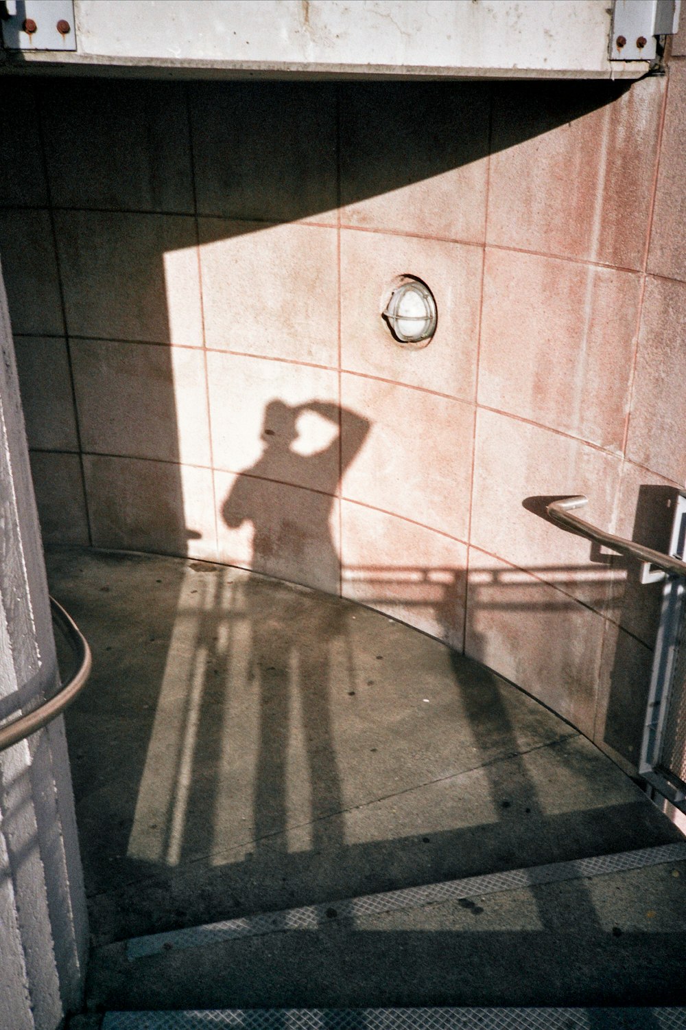 a shadow of a person on a tile floor