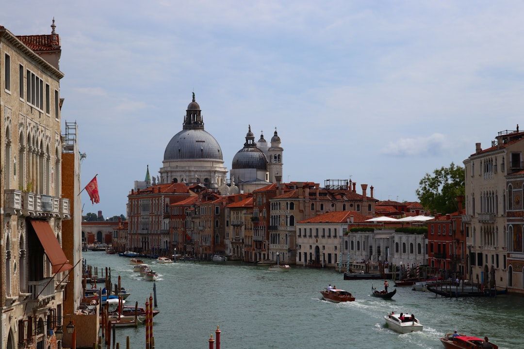 a river with boats and buildings along it, Basilica of Santa Maria della Salute in Venice