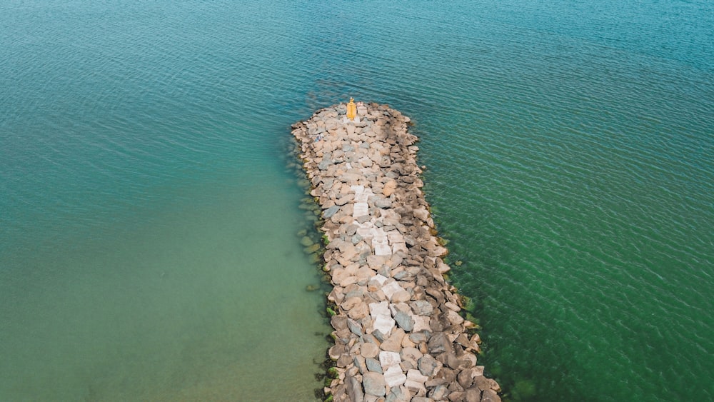 a stack of rocks in the water