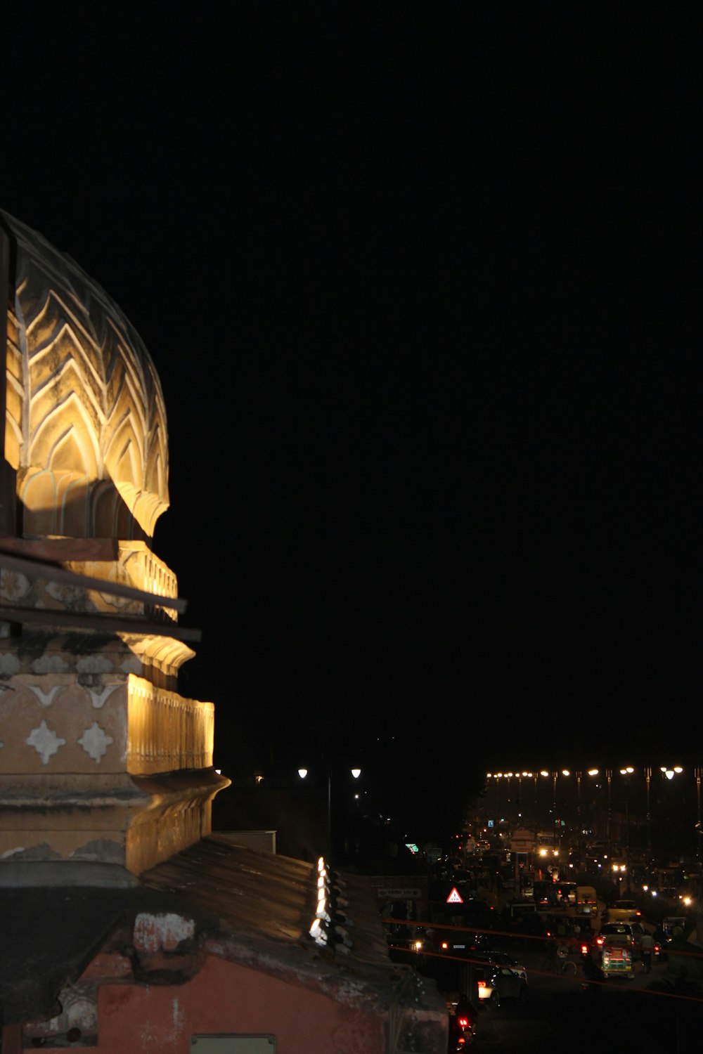 a large tower with a dome at night