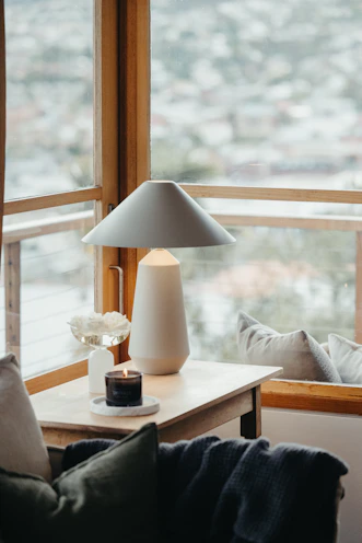 A cozy living room scene with fresh air fresheners and surface wipes placed on a side table.