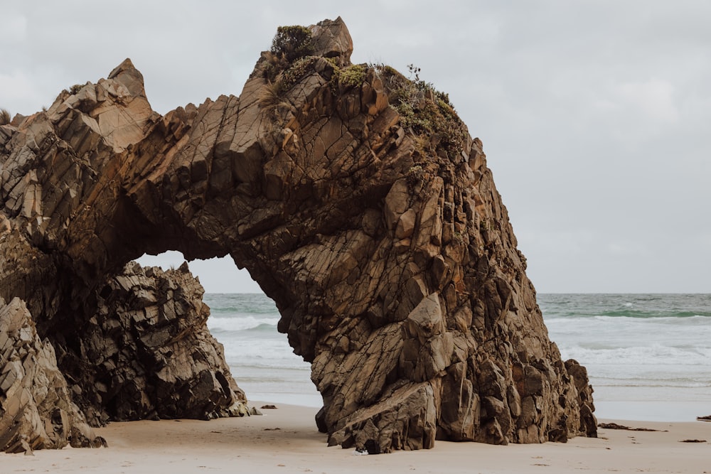 a large rock formation on a beach