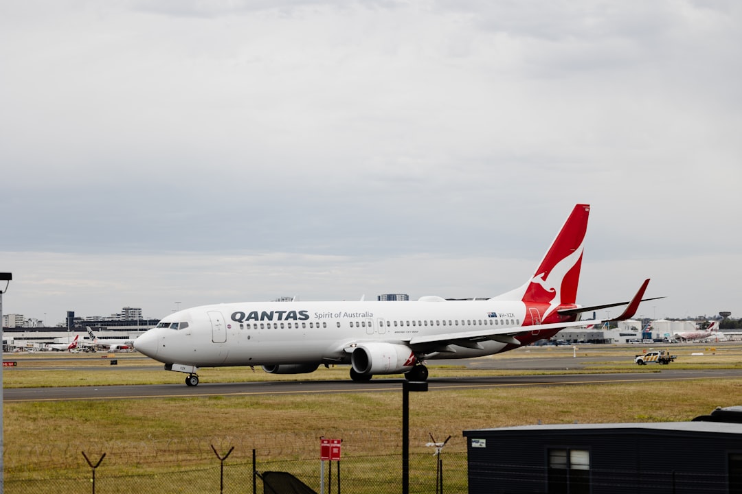 a large white airplane on a runway, Qantas VH-XZK