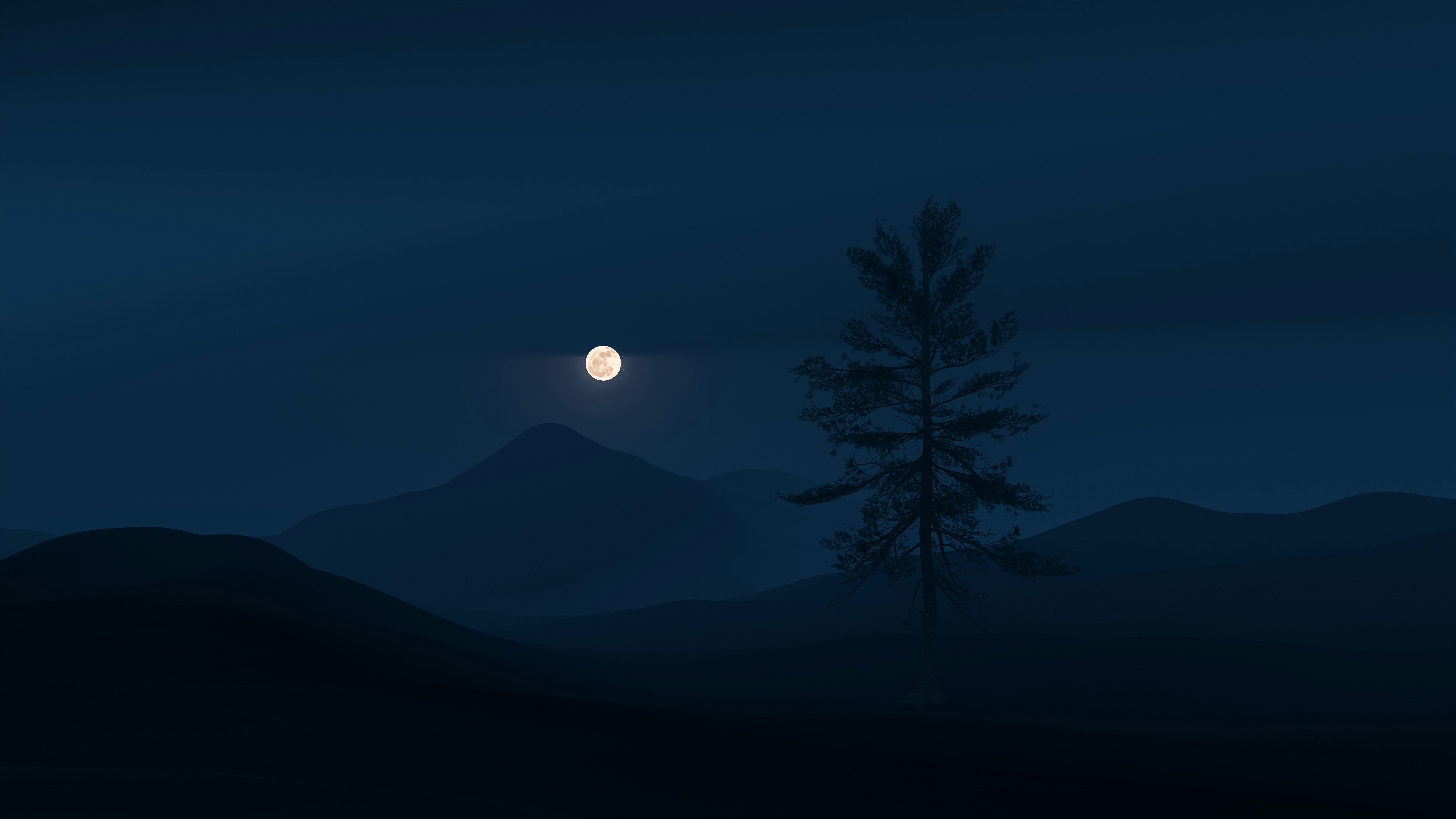 a tree in front of a mountain