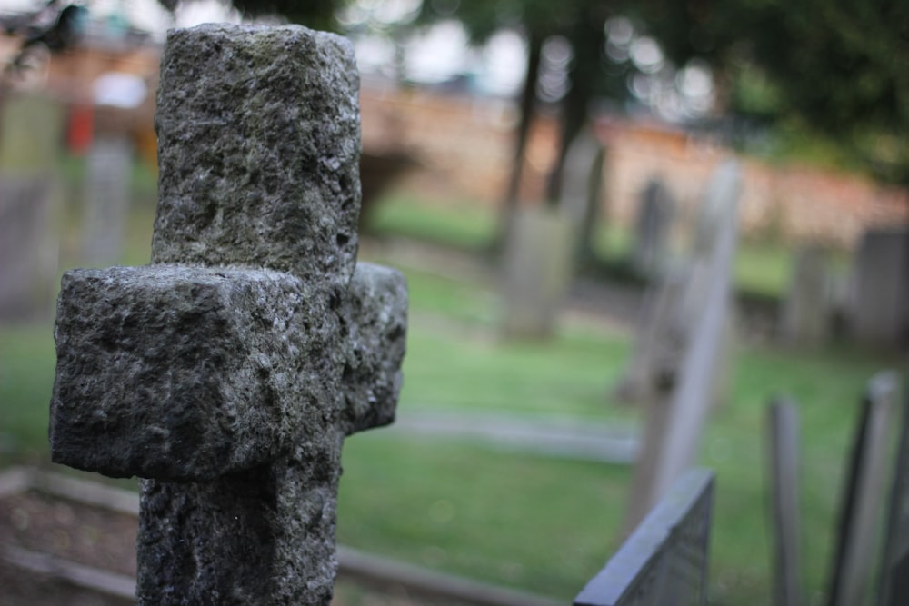 a stone statue on a fence