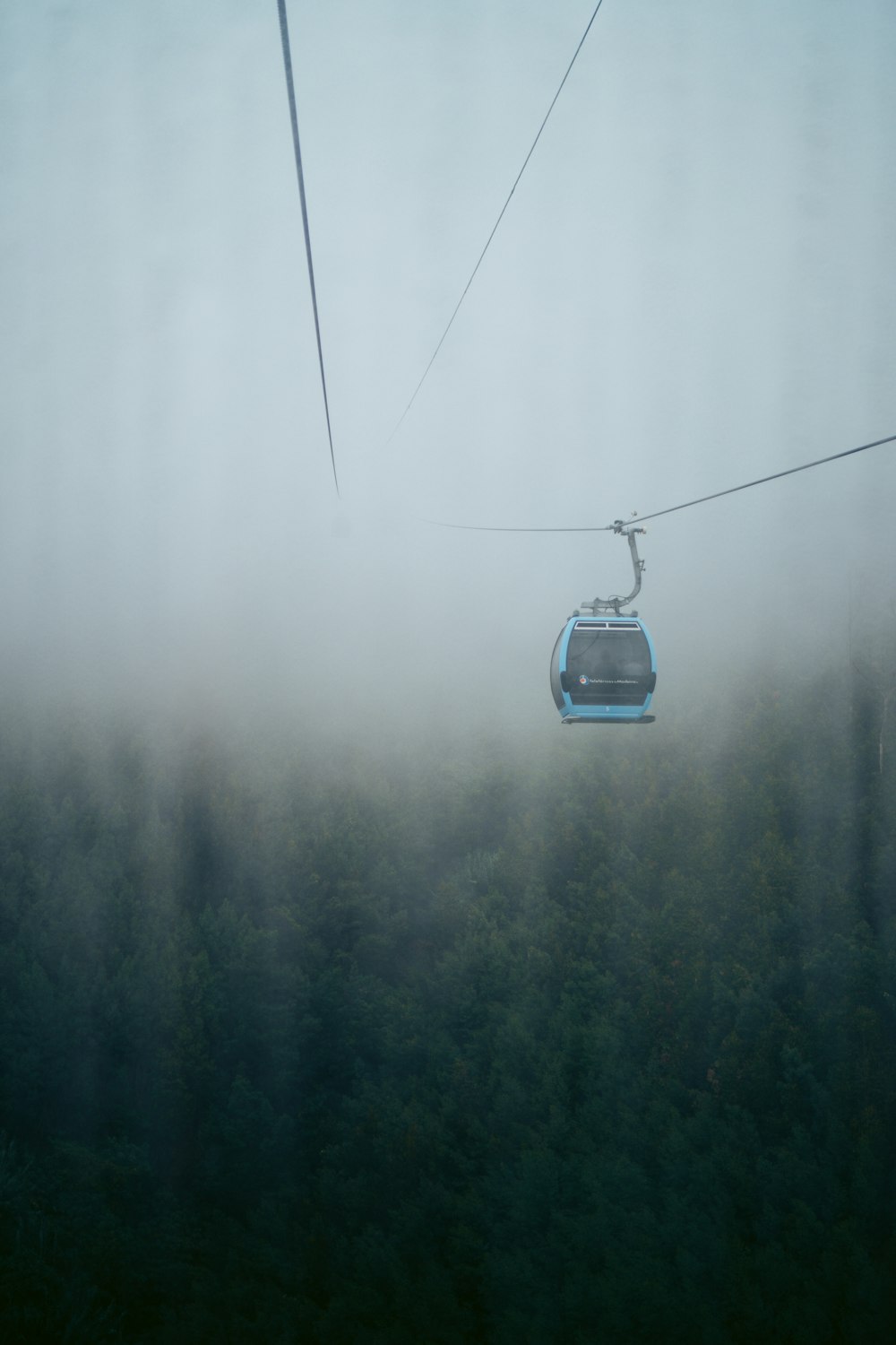 a cable car above trees