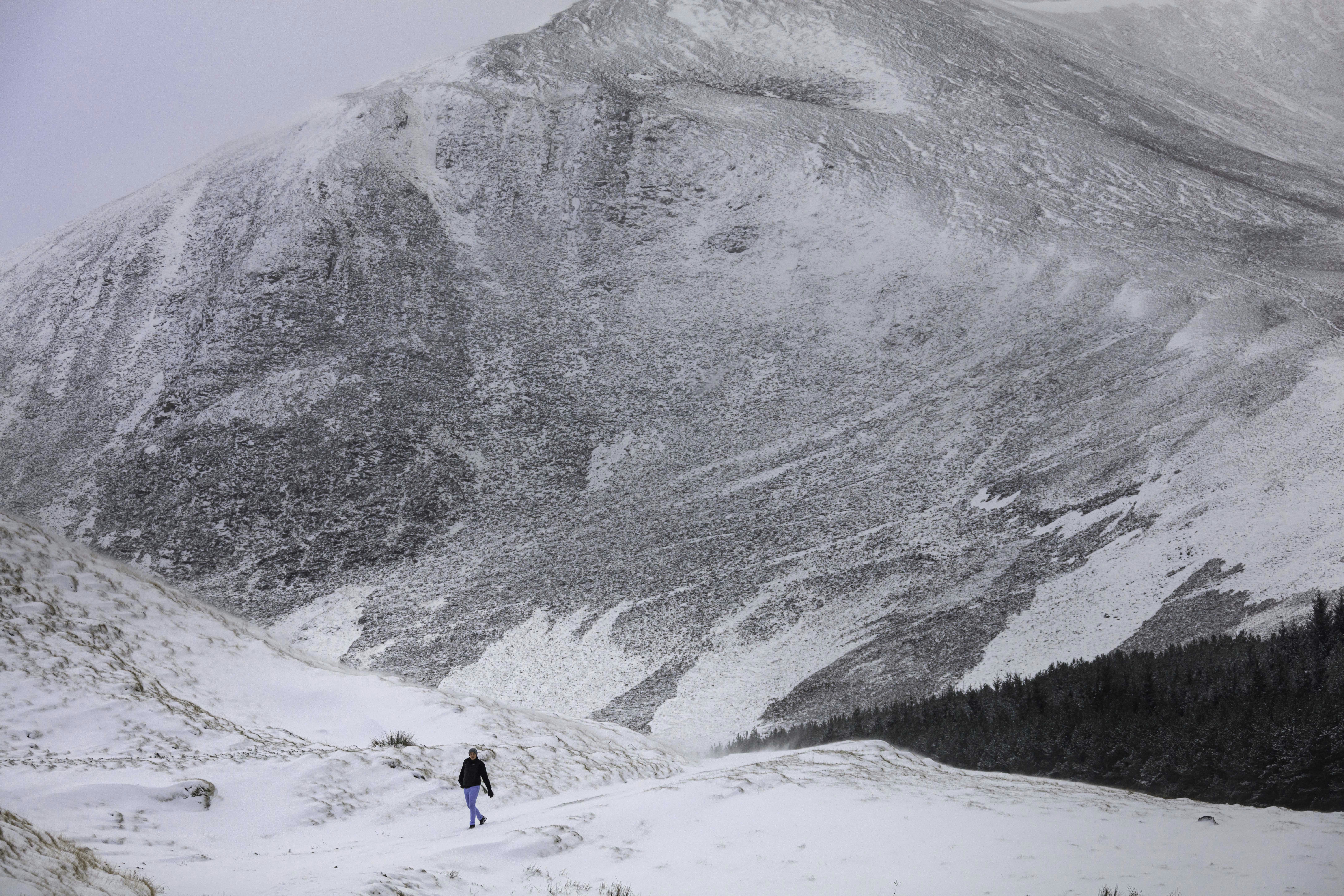 a person walking on a snowy mountain