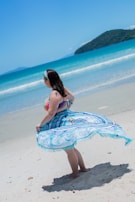 Stylish beachwear featuring bold turquoise patterns against a tropical backdrop.