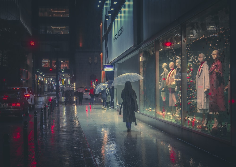 a person walking down a sidewalk with an umbrella