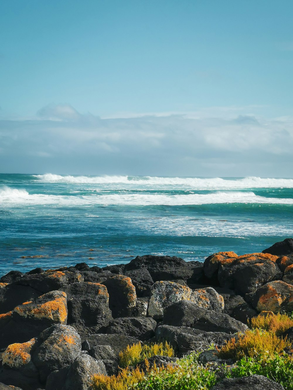 a rocky beach with waves crashing