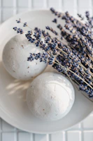 A collection of colorful bath bombs nestled in dried flower petals.