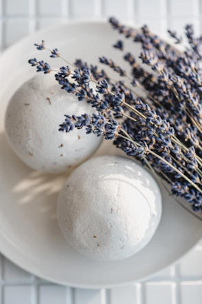 A collection of colorful bath bombs nestled in dried flower petals.