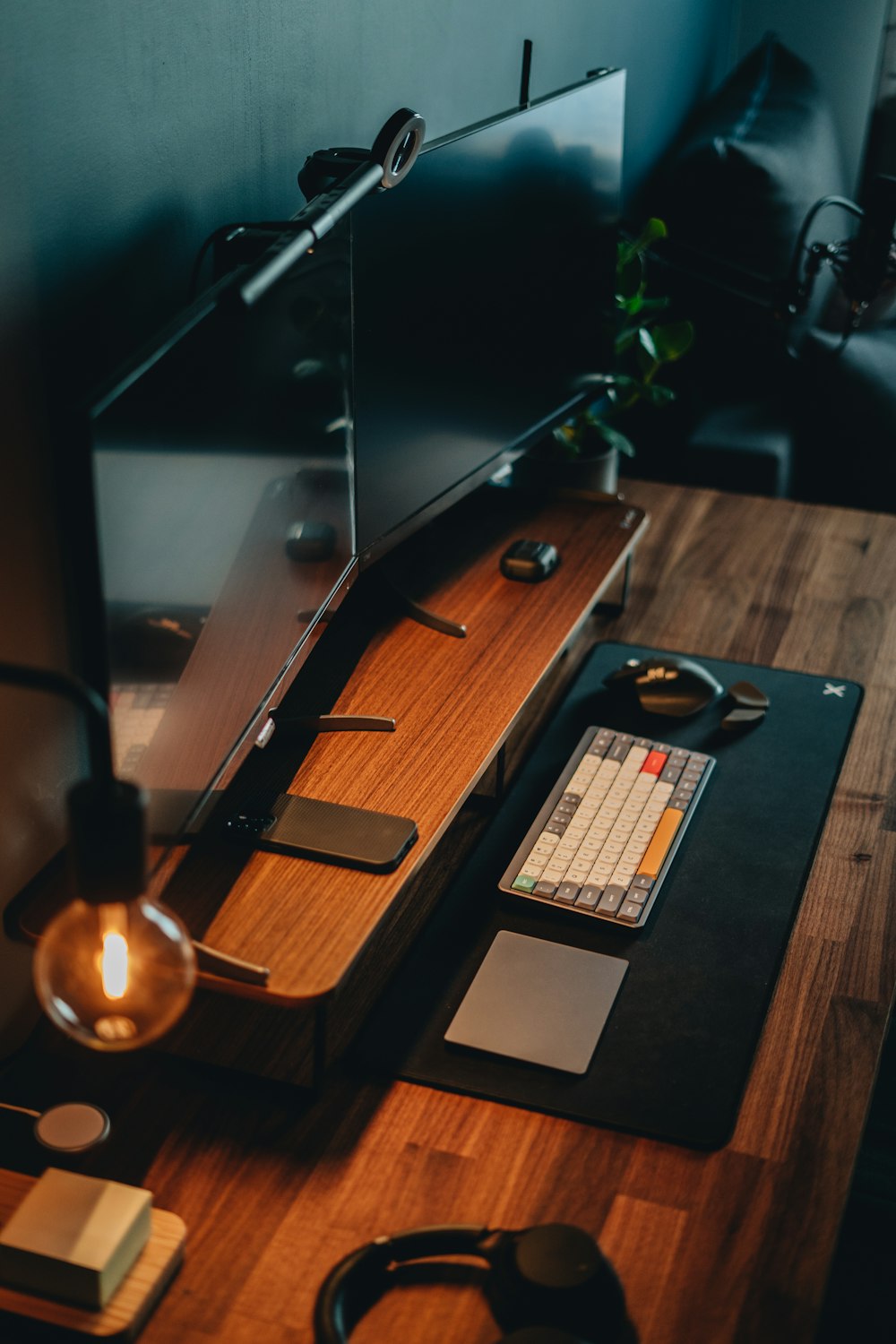 a desk with a computer and a lamp