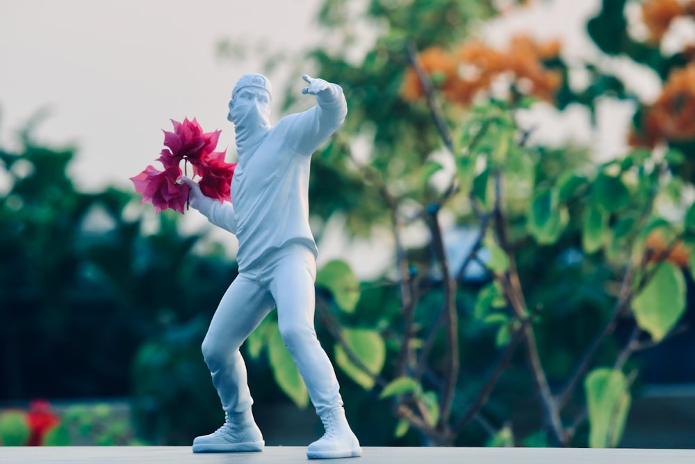 a statue of a person holding a flower