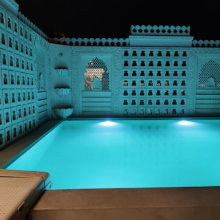 Spa area with tranquil pools reflecting the moonlight and elegant dark finishes.