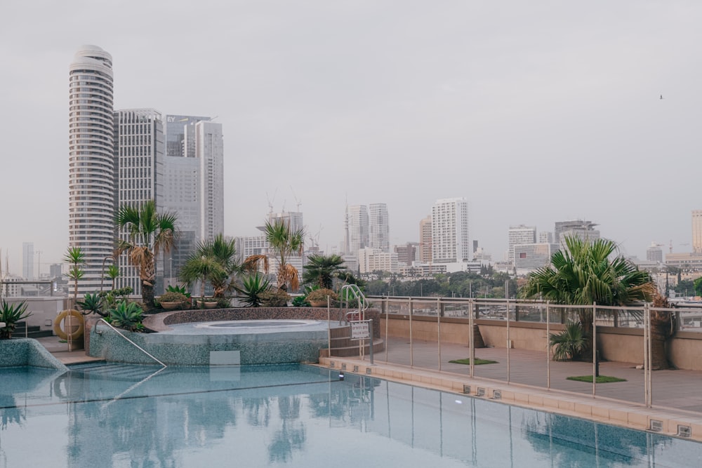 a pool with a city in the background