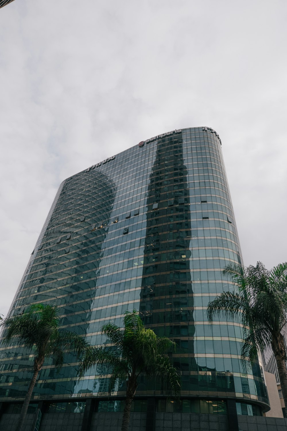 a tall building with trees in front of it