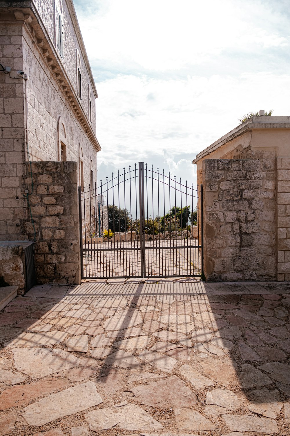 a gate in a stone courtyard