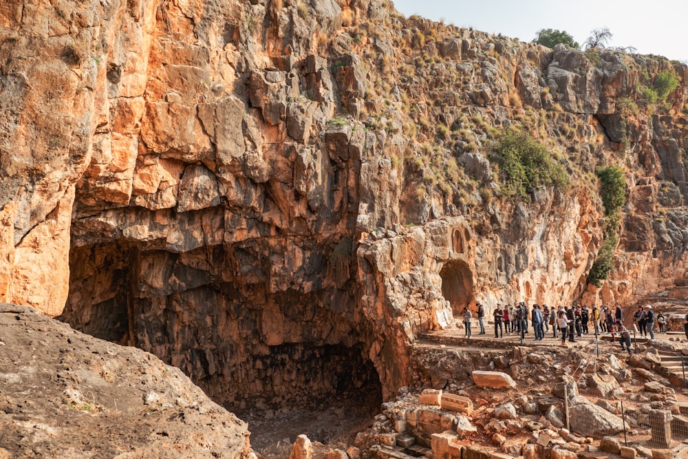 a group of people standing on a cliff side