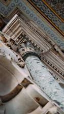 A close-up of a finely detailed stone column blending classical craftsmanship with modern minimalism.
