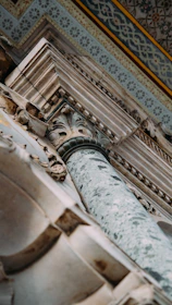 A close-up of a finely detailed stone column blending classical craftsmanship with modern minimalism.